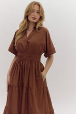 Solid Short Sleeve Collared Tiered Midi Dress featuring button up detail at bust. Pockets at side. Lined.