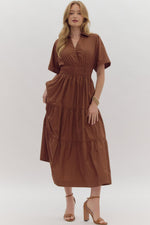 Solid Short Sleeve Collared Tiered Midi Dress featuring button up detail at bust. Pockets at side. Lined.