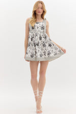 Floral print shoulder tie babydoll dress pullover mini dress featuring stripe pattern border hem. Elasticated smocking at back. Pockets at side.