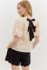 Solid Applique-Textured Bubble Sleeve Featuring Contrast Accent Bow Tie Closure at Back.