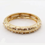 TEXTURED GOLD STRETCH BRACELET WITH SMALL PEARL ACCENT