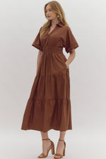 Solid Short Sleeve Collared Tiered Midi Dress featuring button up detail at bust. Pockets at side. Lined.