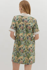 Floral print short sleeve mini dress featuring contrast accent collar button closure and band detail. Pockets at