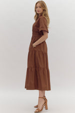 Solid Short Sleeve Collared Tiered Midi Dress featuring button up detail at bust. Pockets at side. Lined.