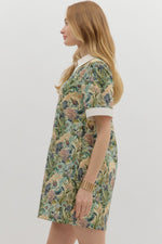 Floral print short sleeve mini dress featuring contrast accent collar button closure and band detail. Pockets at