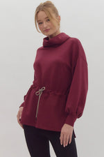 Solid Long Sleeve Tunic featuring Funnel Neck Adjustable Toggle Waist. Side slit at hem.