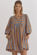 Stripe print babydoll 3/4 sleeve mini dress featuring self tie at front. Elastic at cuff. Pocket at sides.
