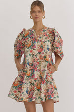 Floral print v-neck puff sleeve mini dress featuring ruffle detail at shoulders. Pocket at sides.