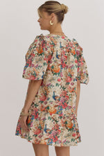 Floral print v-neck puff sleeve mini dress featuring ruffle detail at shoulders. Pocket at sides.