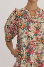 Floral print v-neck puff sleeve mini dress featuring ruffle detail at shoulders. Pocket at sides.