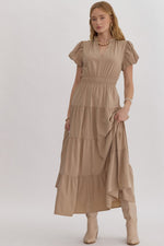 Solid v-neck bubble sleeve tiered midi dress featuring elastic waistband. Ruffle neckline detail.