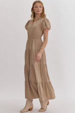 Solid v-neck bubble sleeve tiered midi dress featuring elastic waistband. Ruffle neckline detail.