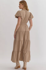 Solid v-neck bubble sleeve tiered midi dress featuring elastic waistband. Ruffle neckline detail.