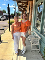 ORANGE KNIT TOP WITH BOW TIE DETAIL ON BACK