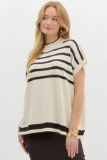 Striped off shoulder oversized sweater knit pullover top featuring mock neck.