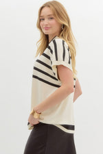 Striped off shoulder oversized sweater knit pullover top featuring mock neck.
