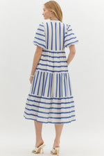 Navy Striped short bubble sleeve pullover dress featuring scallop accent front. Pockets at side. Lined