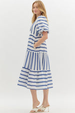 Navy Striped short bubble sleeve pullover dress featuring scallop accent front. Pockets at side. Lined