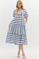 Navy Striped short bubble sleeve pullover dress featuring scallop accent front. Pockets at side. Lined