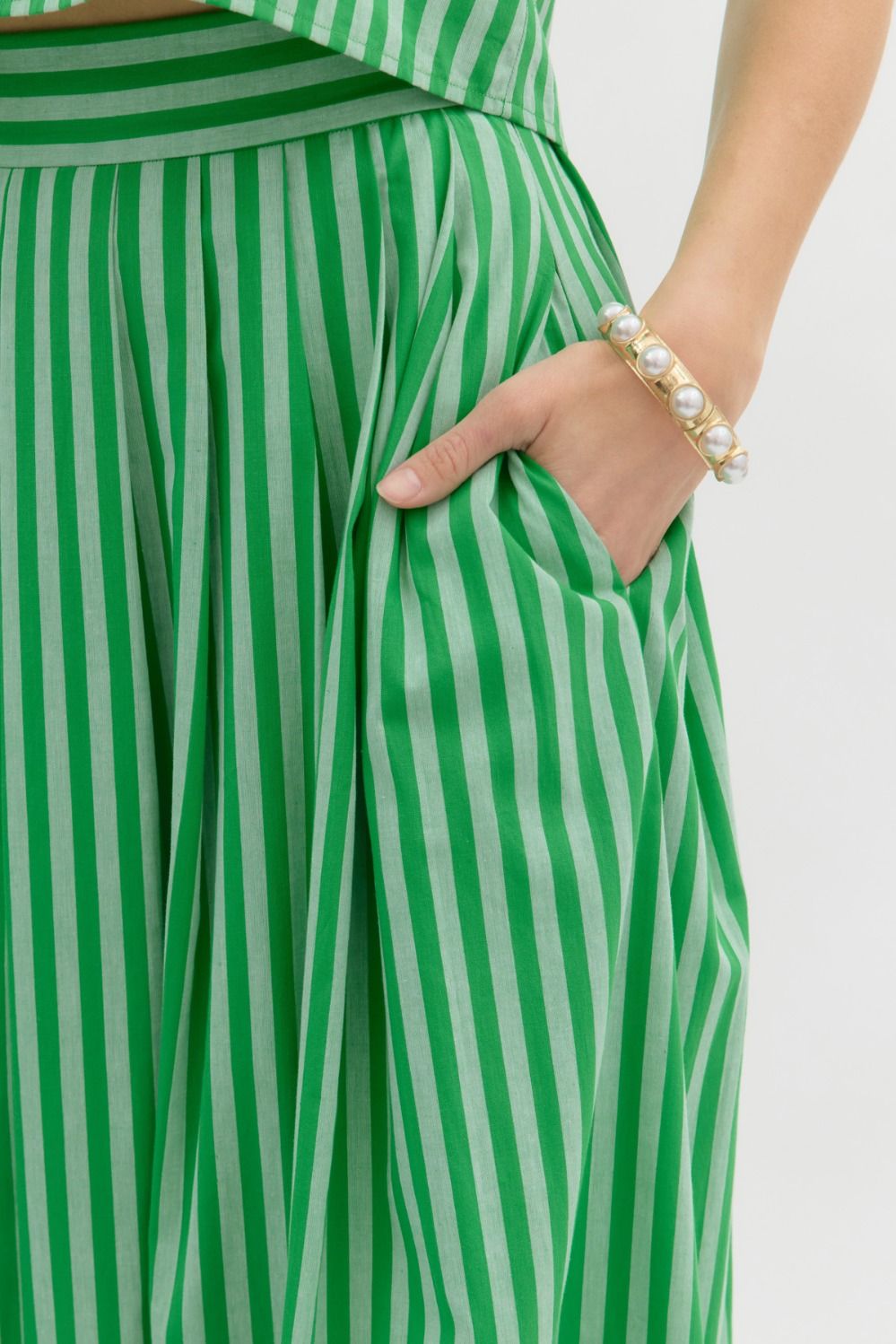 Stripe pattern sleeveless top featuring accented wooden button back closure and Stripe pattern high waist pleated midi skirt -SET
