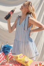 Stripe Print V-neck Sleeveless Mini Dress featuring self tie at shoulders. Pocket at sides. Lined.